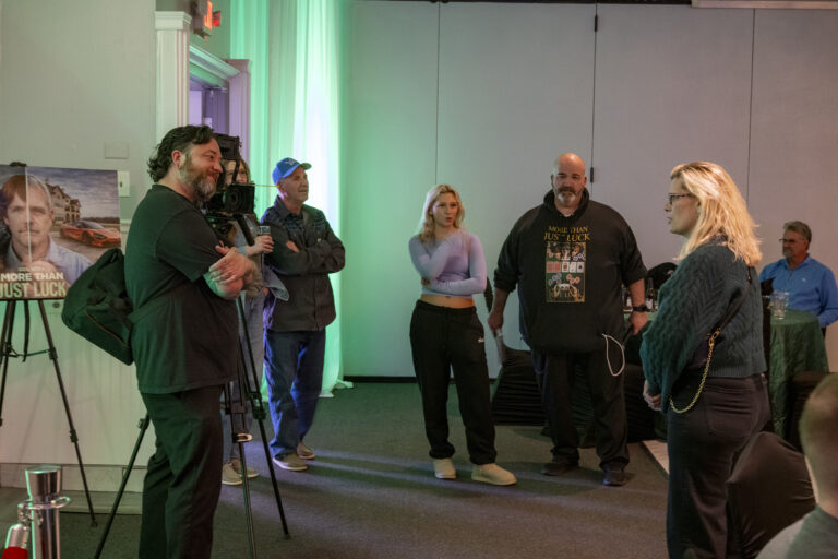 Book release party: A camera operator films guests talking