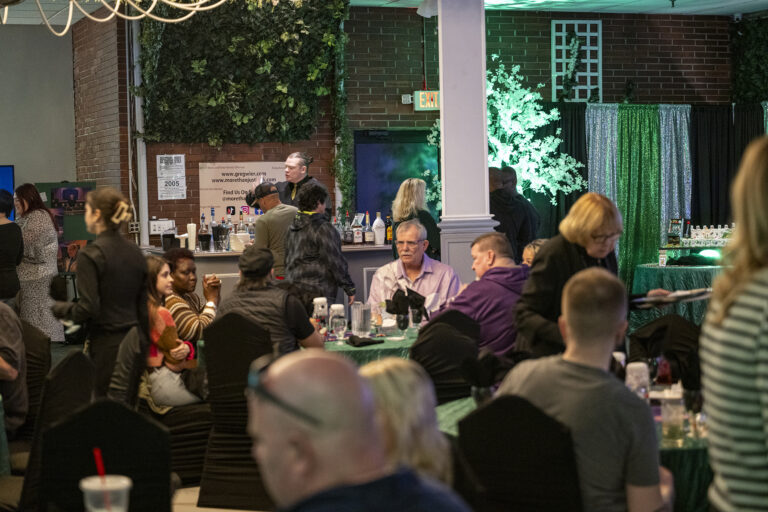 Book release party: Guests seated at tables around the hall