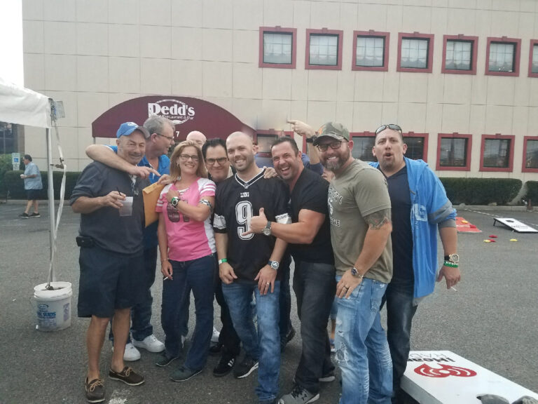 Friends tailgating outside a stadium