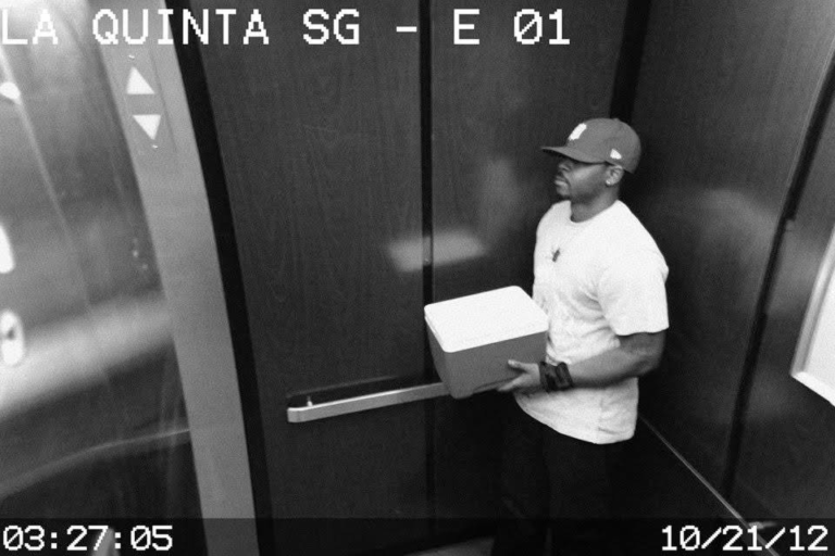 Security camera still of a man in a hallway