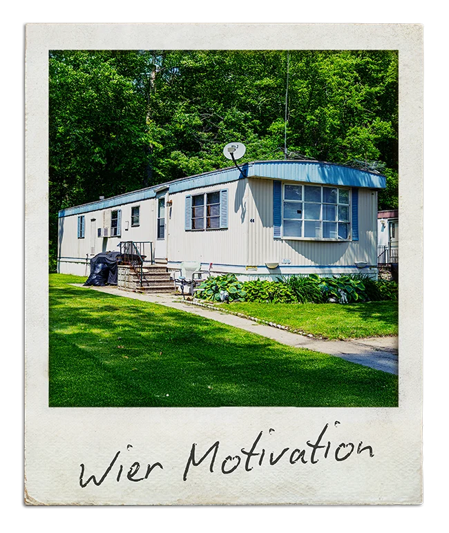 Polaroid captioned "Wier Motivation": a single-wide mobile home