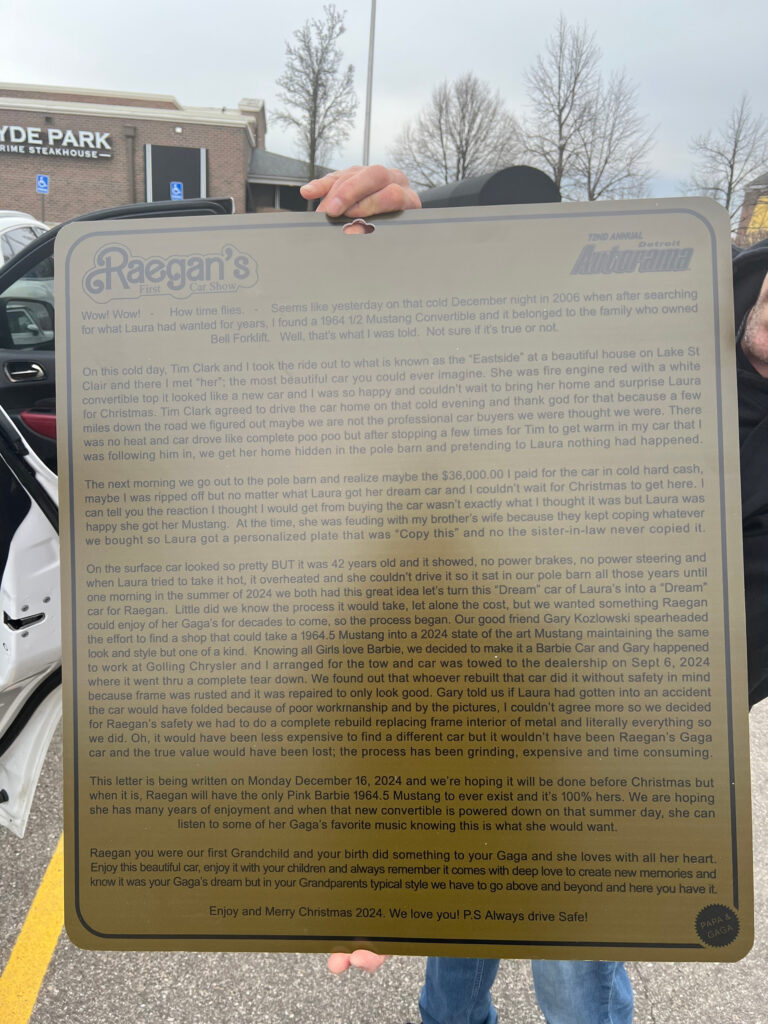 A man holding up a framed certificate