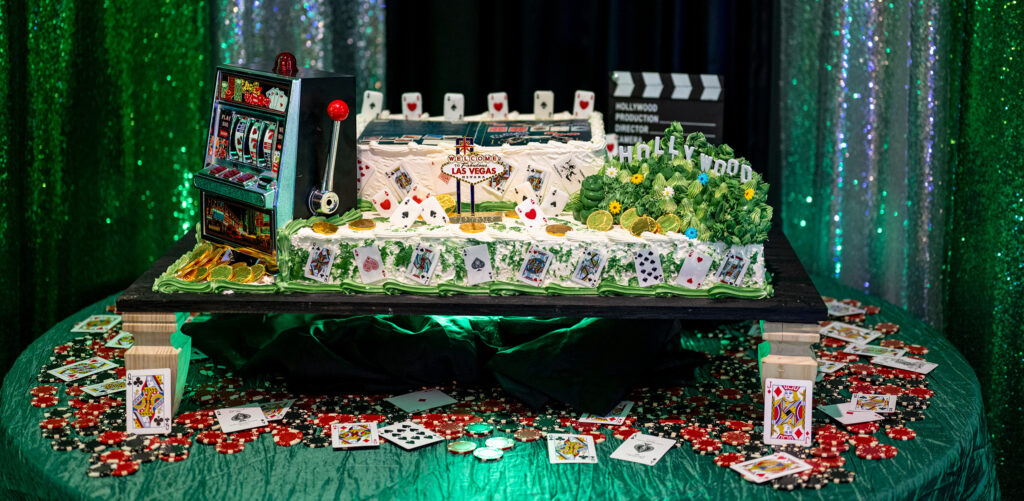 Casino-themed release party cake on a table of poker chips and cards