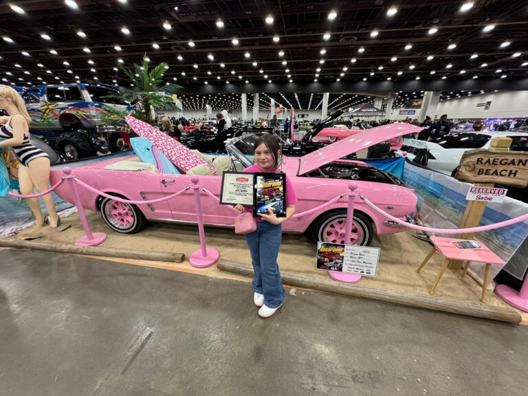 Pink Mustang on display at a car show