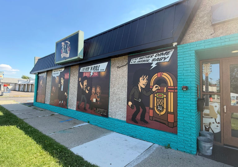 Teal building with music-themed murals
