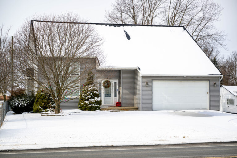 Two-story house with a garage in the snow